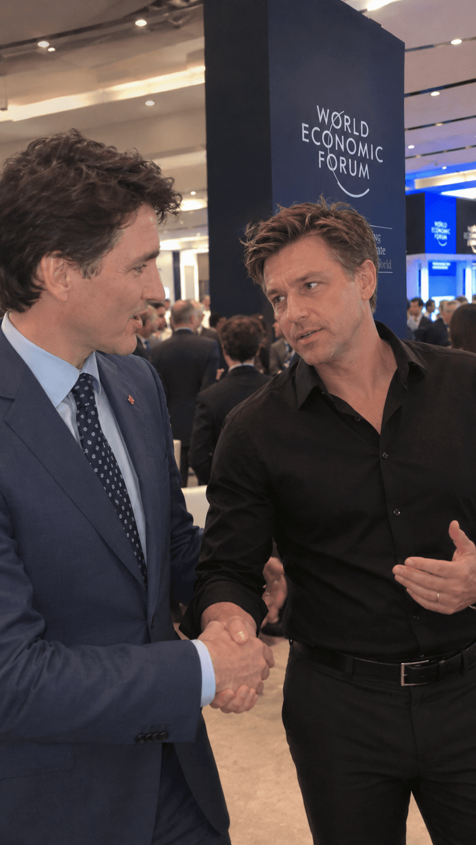 Tony in a black shirt, mid-conversation with another guest at a busy event